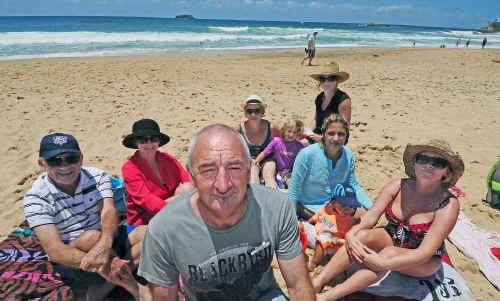Split Solitary Beach Holiday Park owner David Barry with visiting families on Sapphire Beach yesterday. Split Solitary Beach Holiday Park owner David Barry with visiting families on Sapphire Beach yesterday.